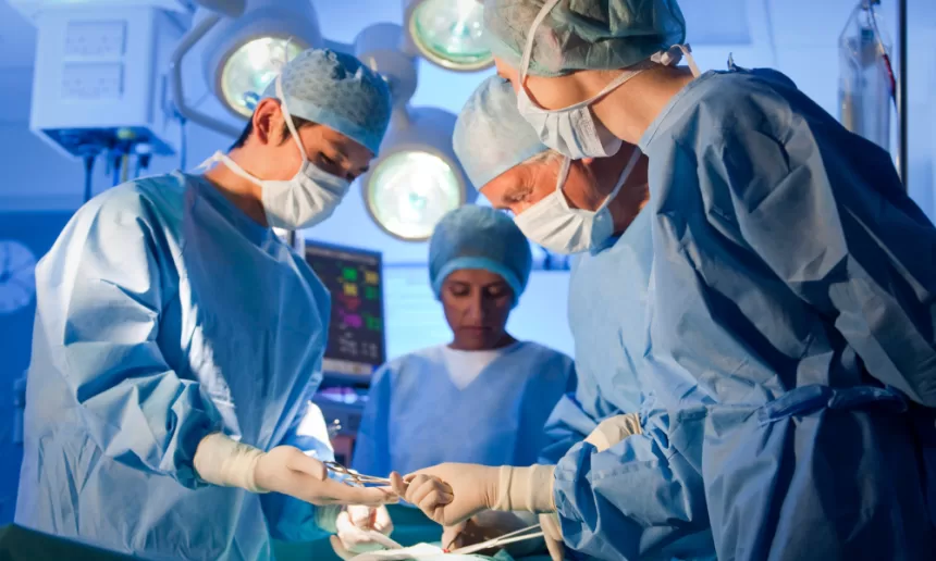Surgeons conducting anorectal malformation surgery in a sterile operating room, focused on patient care and precision.