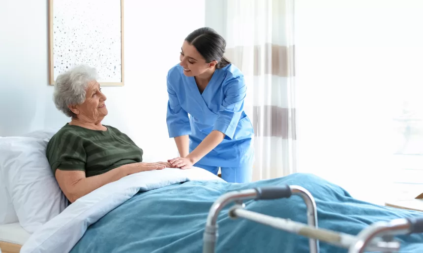 A nurse assists an elderly woman in bed, providing care and support post-bariatric surgery.