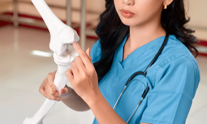 A female nurse holds a bone, symbolizing hope in bone marrow transplantation and patient care.