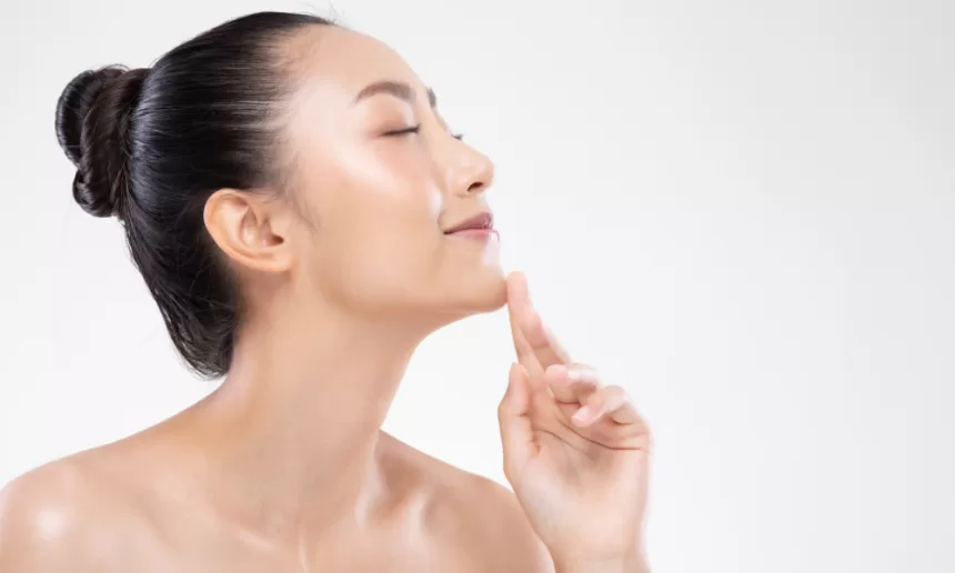 A woman with a smooth, clear complexion showcasing her chin augmentation, radiating confidence and beauty.