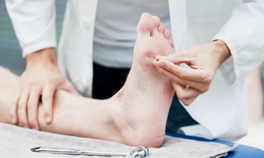 A person receiving a foot massage with a needle, highlighting diabetic foot surgery treatment techniques.