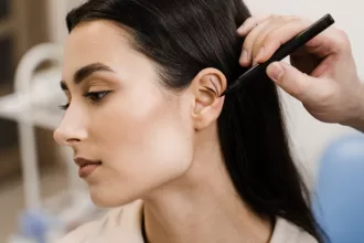 A woman receives a haircut from a stylist, showcasing her new look and confidence in a salon setting.