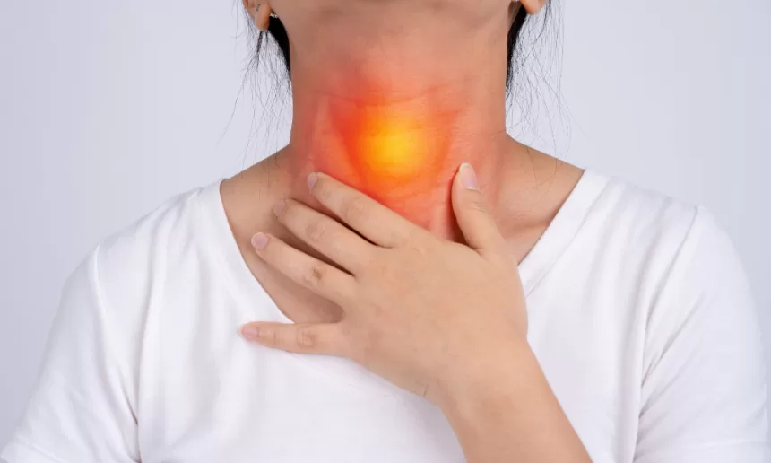 A woman with a sore throat and a red spot on her neck, reflecting her recovery from esophageal cancer surgery.