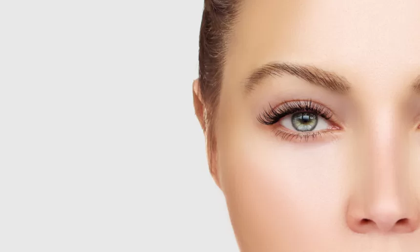 A close-up of a woman's face highlighting her green eye, symbolizing resilience after eye tumor surgery.