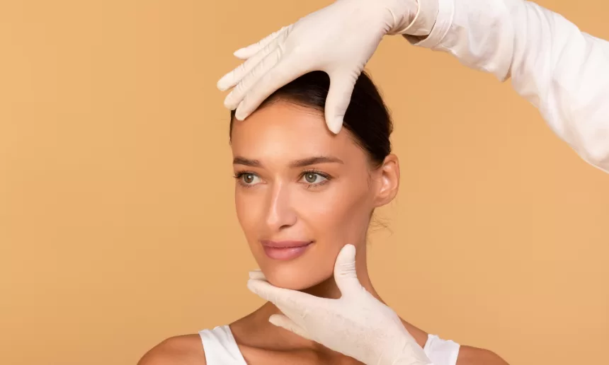 A woman undergoing face lift surgery, receiving treatment from a doctor in a clinical setting.