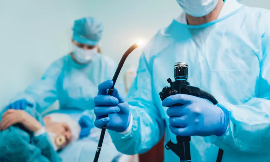 Two doctors in blue scrubs hold a torch, symbolizing guidance in Functional Endoscopic Sinus Surgery (FESS).