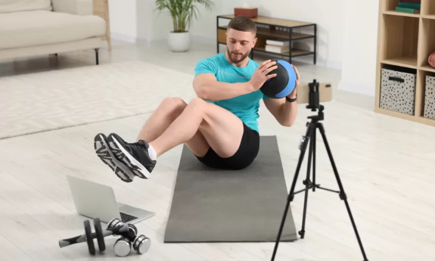 A fitness coach demonstrating exercises in a modern gym, combining strength training and cardio workouts, representing a hybrid workout program for a balanced fitness routine.