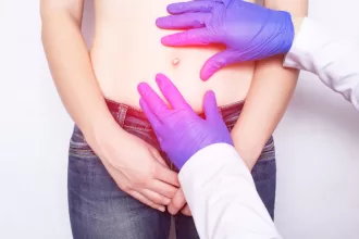 Doctor discussing hernia surgery risks with a patient in a clinical setting, showcasing concern and reassurance.