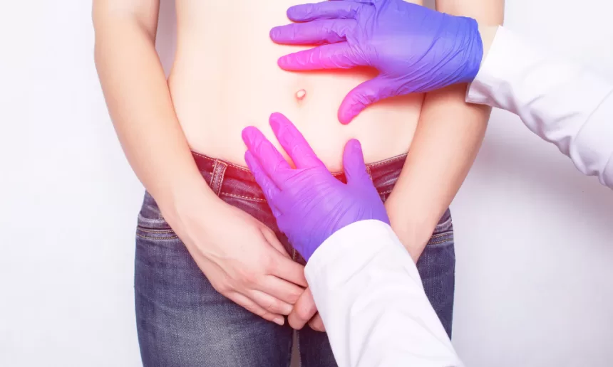 Doctor discussing hernia surgery risks with a patient in a clinical setting, showcasing concern and reassurance.