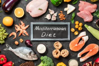 A colorful spread of Mediterranean diet foods, featuring fresh vegetables, grains, and healthy fats on a rustic table.