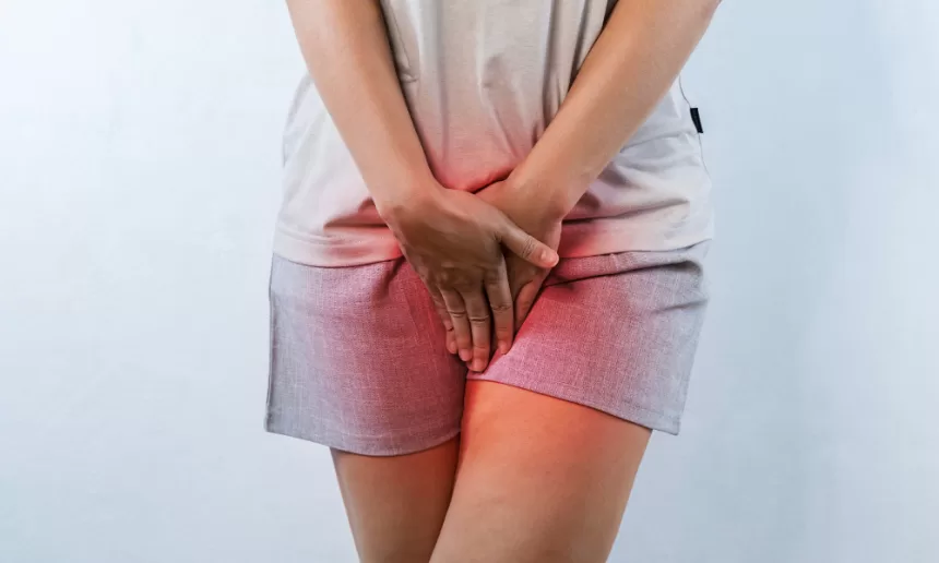 A woman experiencing stomach pain, highlighting the impact of pelvic organ prolapse repair on her well-being.