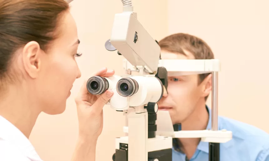A woman undergoing an eye exam, focusing on retinal detachment repair, highlighting the importance of eye health.