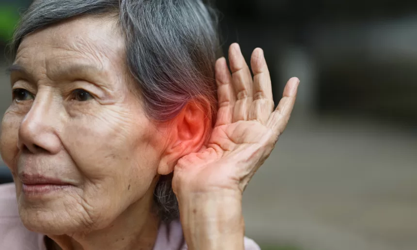 A person receiving an ear piercing, highlighting the procedure and the importance of ear health in relation to hearing loss.