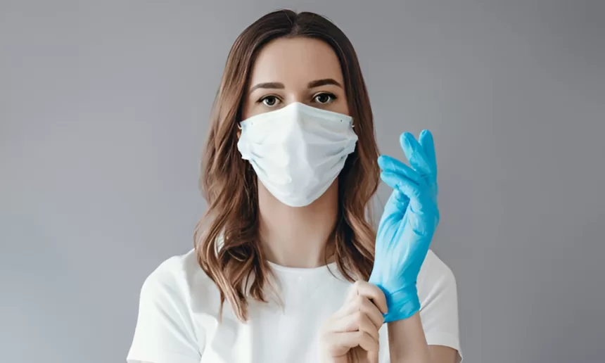 A woman in a surgical mask and blue gloves, emphasizing the importance of sterilization in healthcare settings.