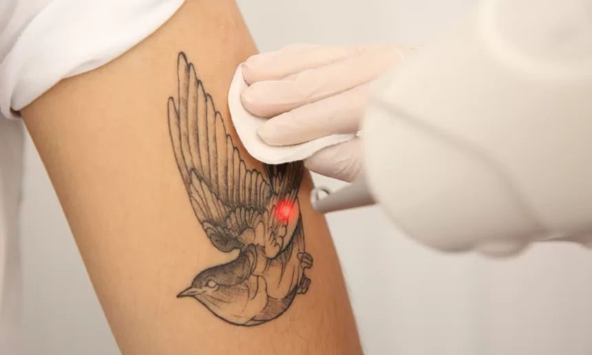 A person receiving a tattoo on their arm, highlighting the artistry and detail involved in the tattooing process.